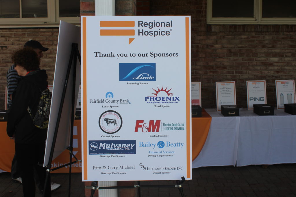 sign with sponsors for regional hospice annual golf tournament